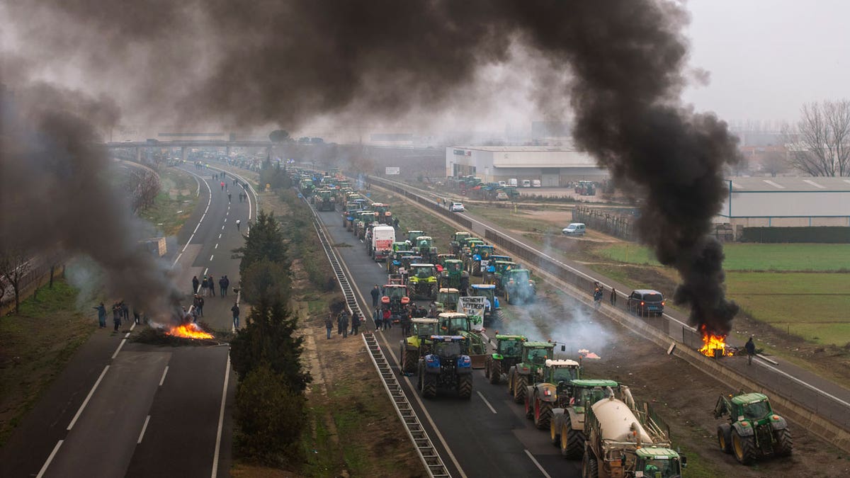 Farmers make barricades after blocking a highway during a protest near Mollerussa, northeast Spain