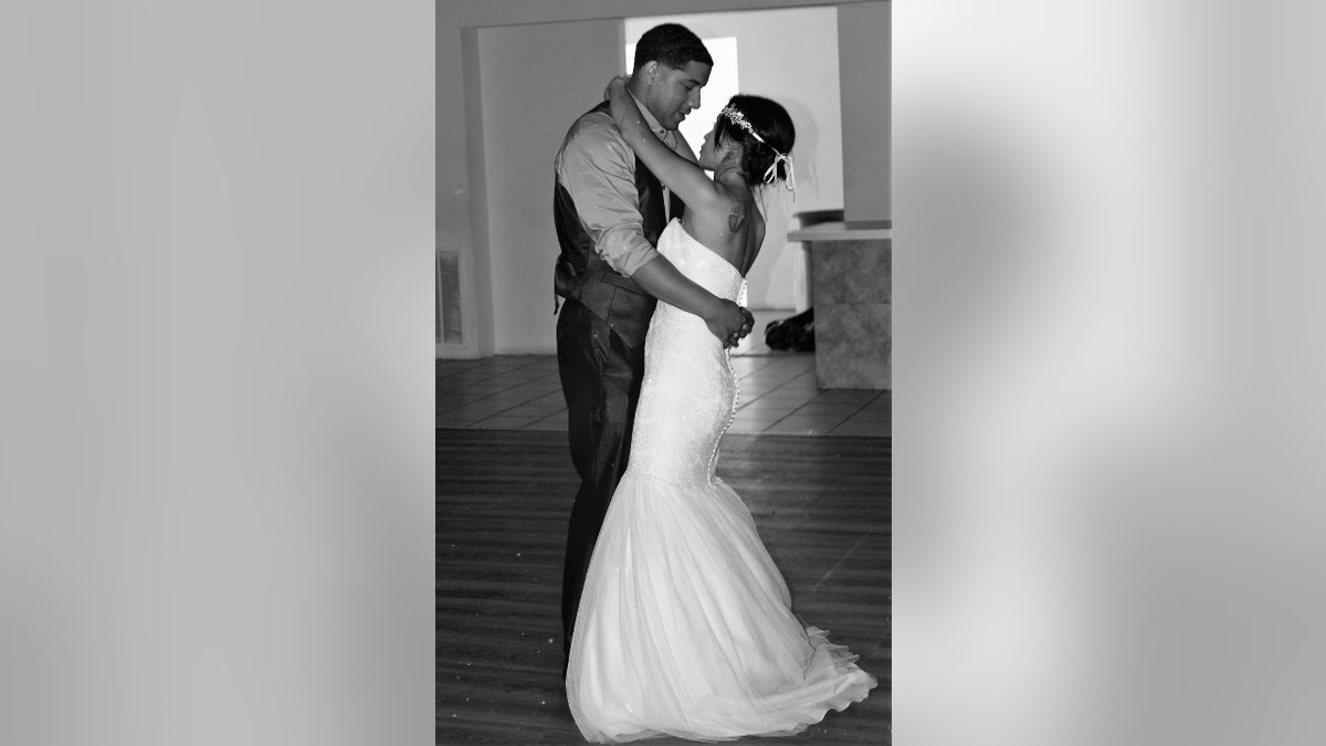 Christopher Fitzgerald dances with his wife at their wedding