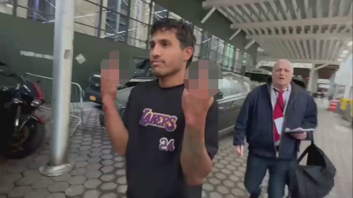 Migrant flips off reporters after NYPD assault