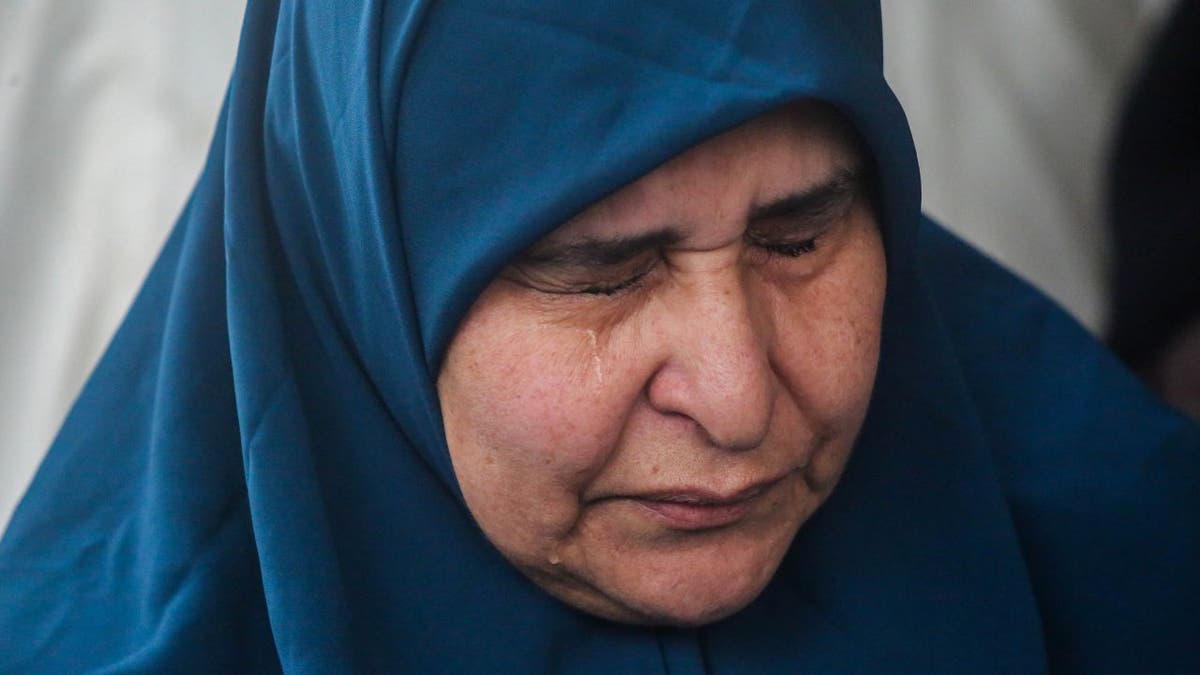A woman cries in mourning after Israeli airstrikes killed 28 people.