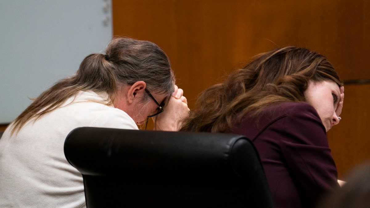 Jennifer Crumbley, left, weeps as her attorney Shannon Smith holds her head in her hands as surveillance video was displayed for the jury showing the 2021 shooting at Oxford High School in the Oakland County courtroom Thursday, Feb. 1, 2024 in Pontiac, Mich.