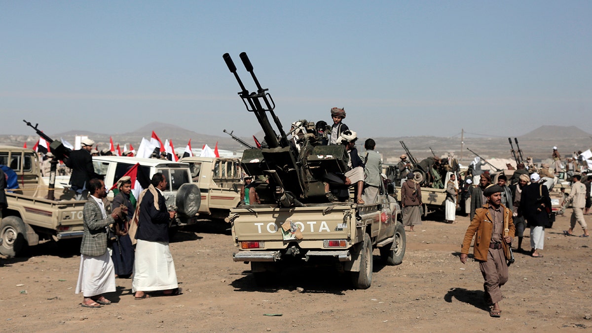 Houthi militants in vehicles