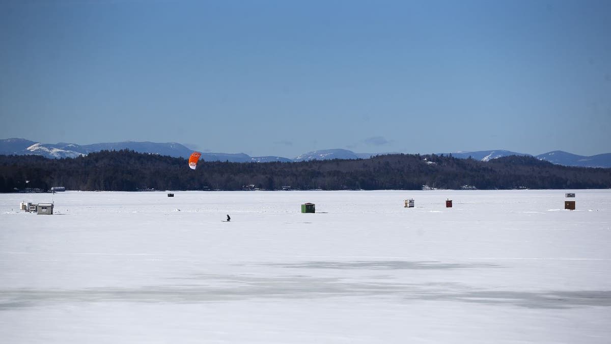 Wide shot of ice fishing sheds in Maine
