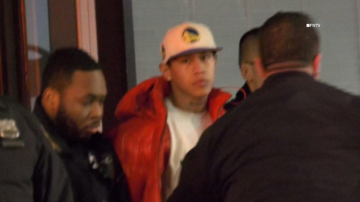 Suspect in orange puffer jacket patted down by NYPD