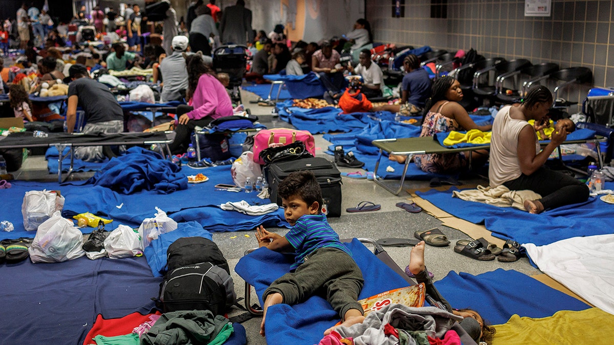 Migrants on the floor and on cots at a makeshift shelter at Chicago's O'Hare International Airport