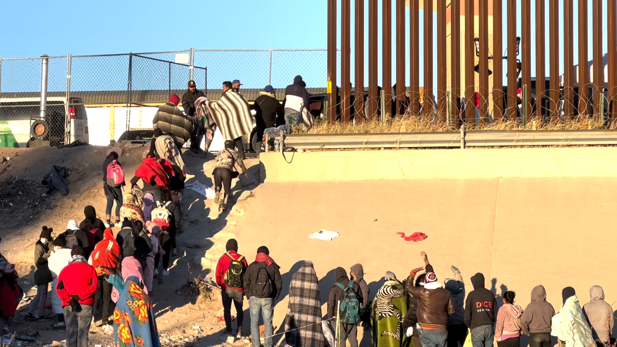 Migrants standing in line at the Border