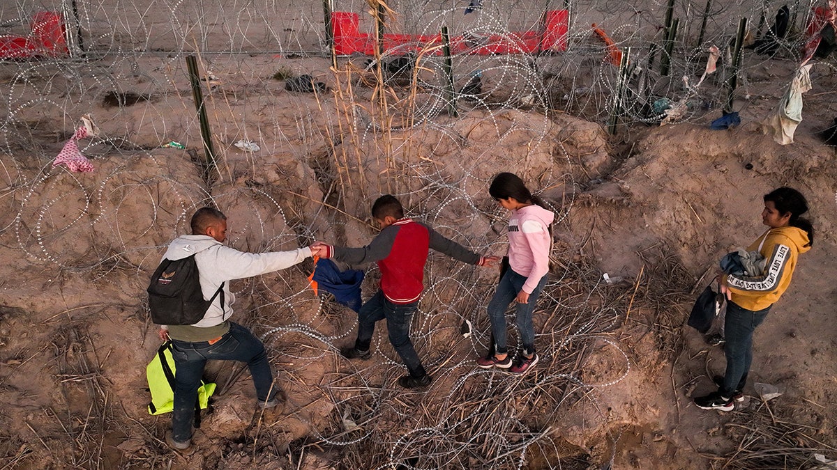 Migrant children cross by Eagle Pass Texas