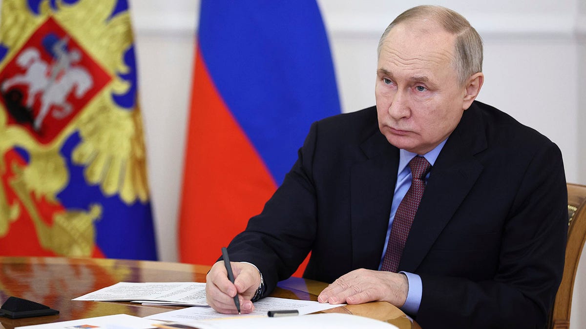 Putin signing document