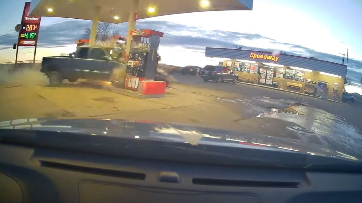 Truck runs into gas pumps
