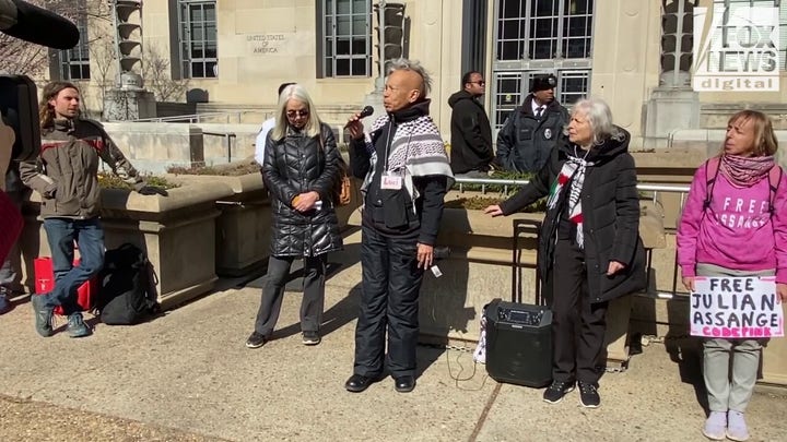 Singer and activist Luci Murphy sang with supporters of Julian Assange outside the DOJ