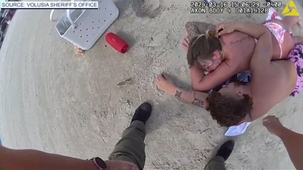 Couple passed out on Florida beach