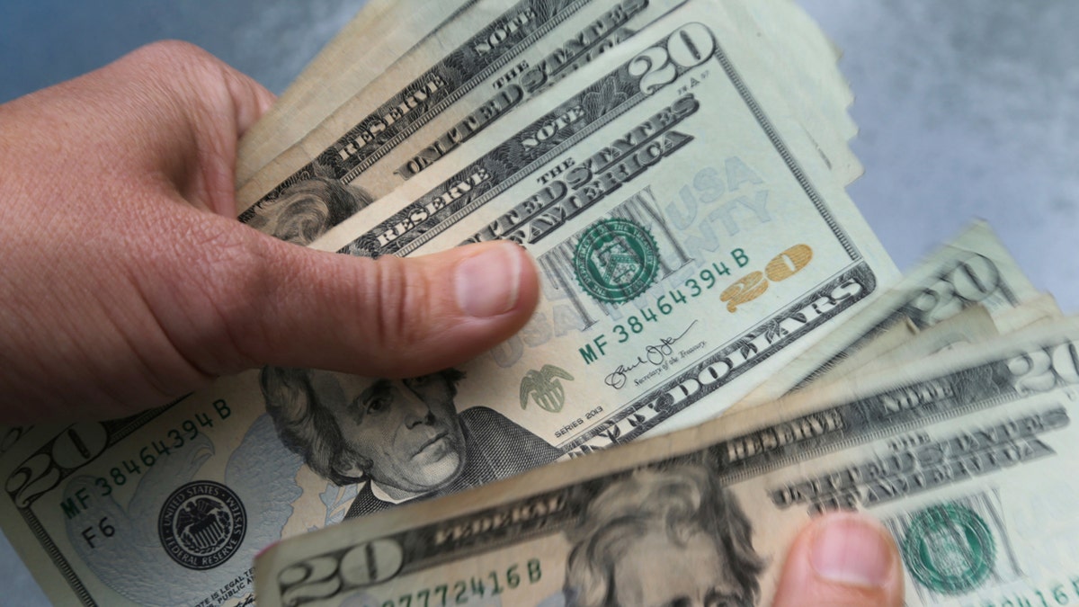 Close up of hands holding cash