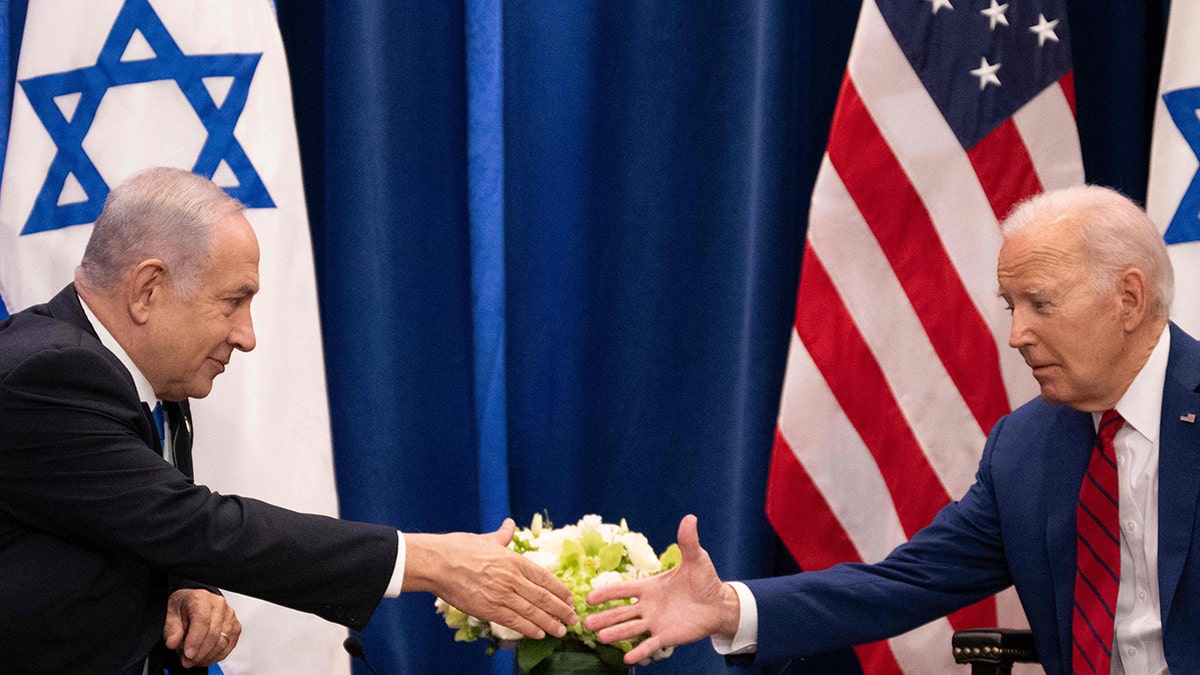 Biden shaking hands with Netanyahu
