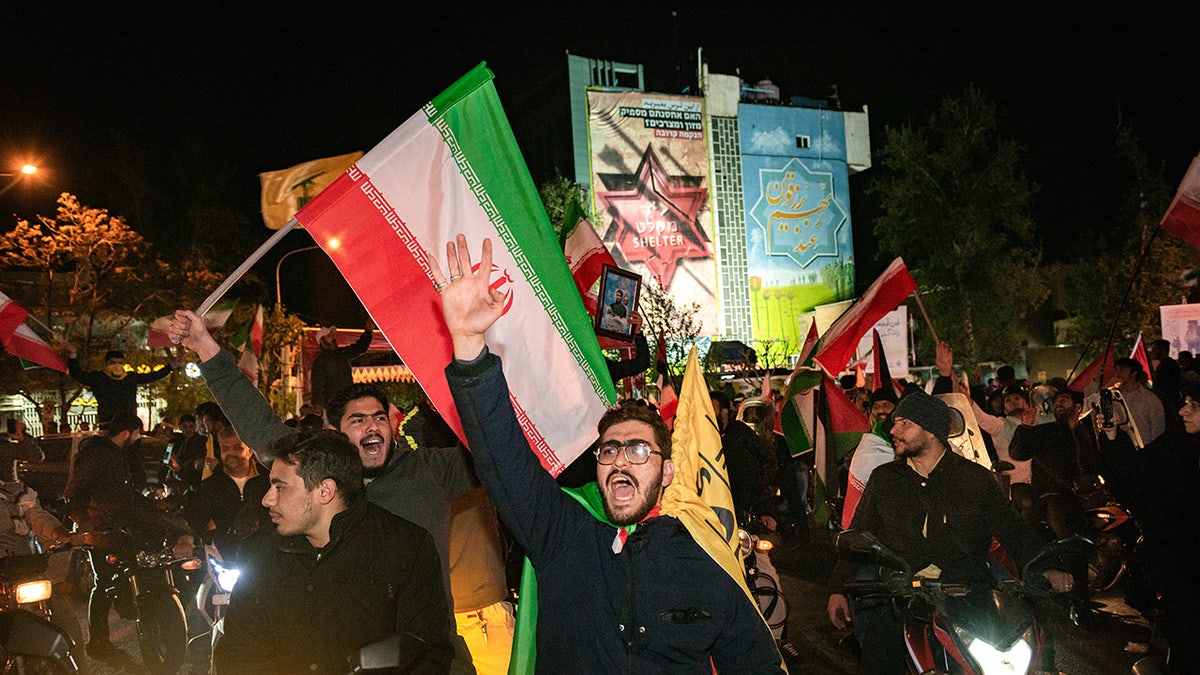 Iranian pro-government supporters shout anti-Israel slogans during a protest