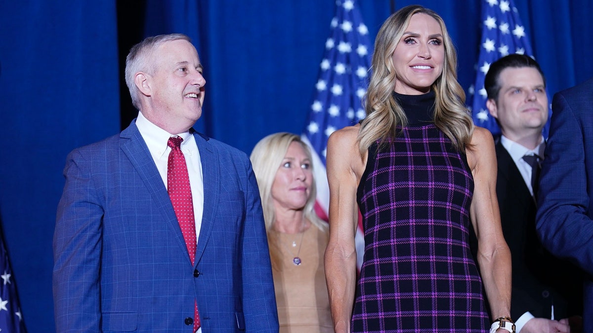 Lara Trump, right, with Michael Whatley, left at rally