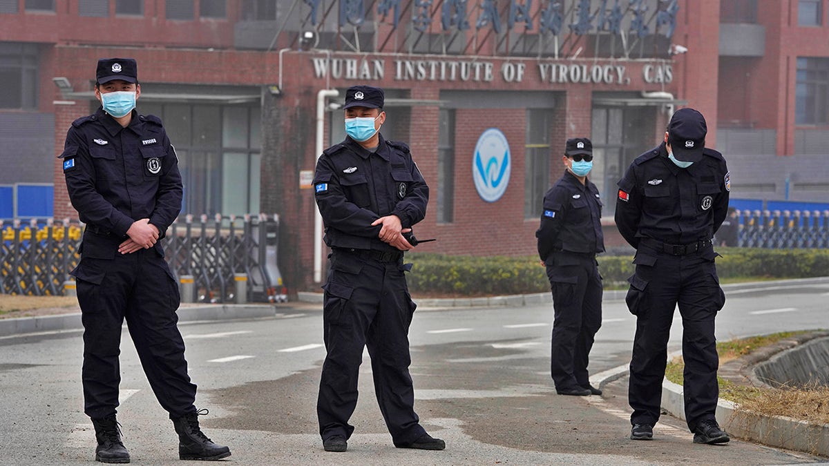 Security personnel gather near the entrance of the Wuhan Institute of Virology during a visit by the World Health Organization team in Wuhan in Chinas Hubei province on Wednesday, Feb. 3, 2021. (AP Photo/Ng Han Guan)