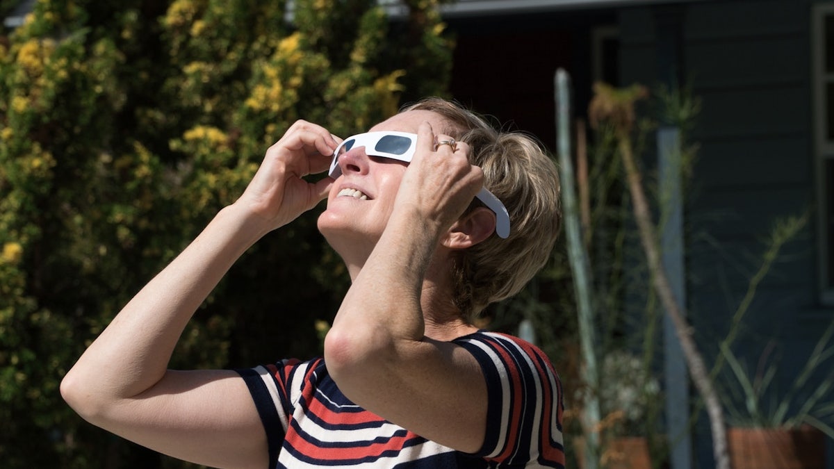 A woman views an eclipse