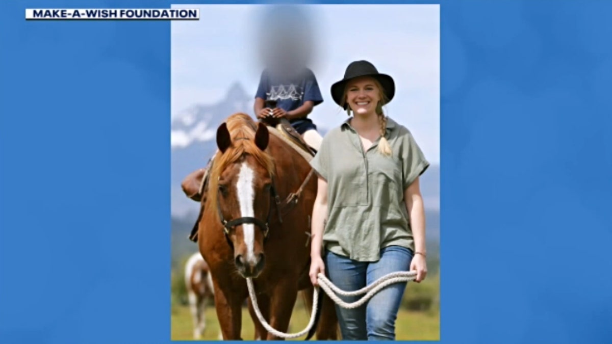 Sophie Hartman walks next to her daughter riding a horse