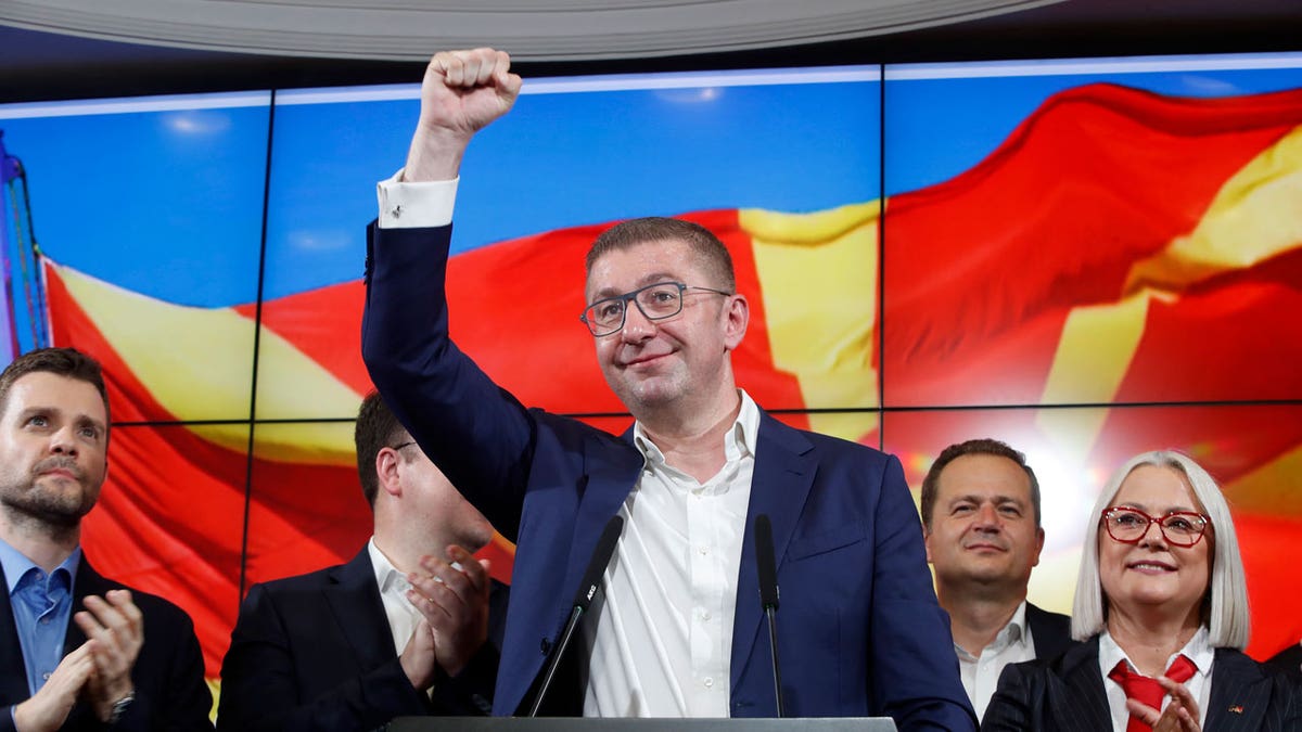 Hristijan Mickoski, the leader of the opposition center-right VMRO-DPMNE party in North Macedonia, celebrates after a news conference