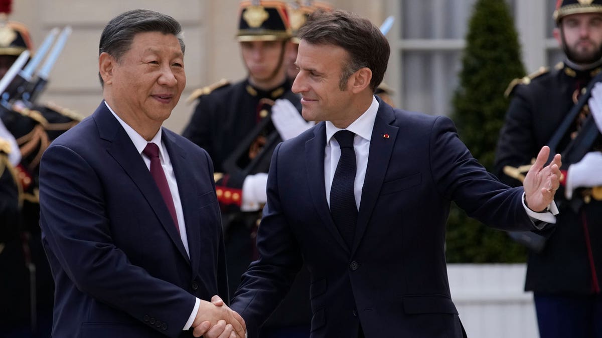 French President Emmanuel Macron welcomes China's President Xi Jinping to the Elysee Palace