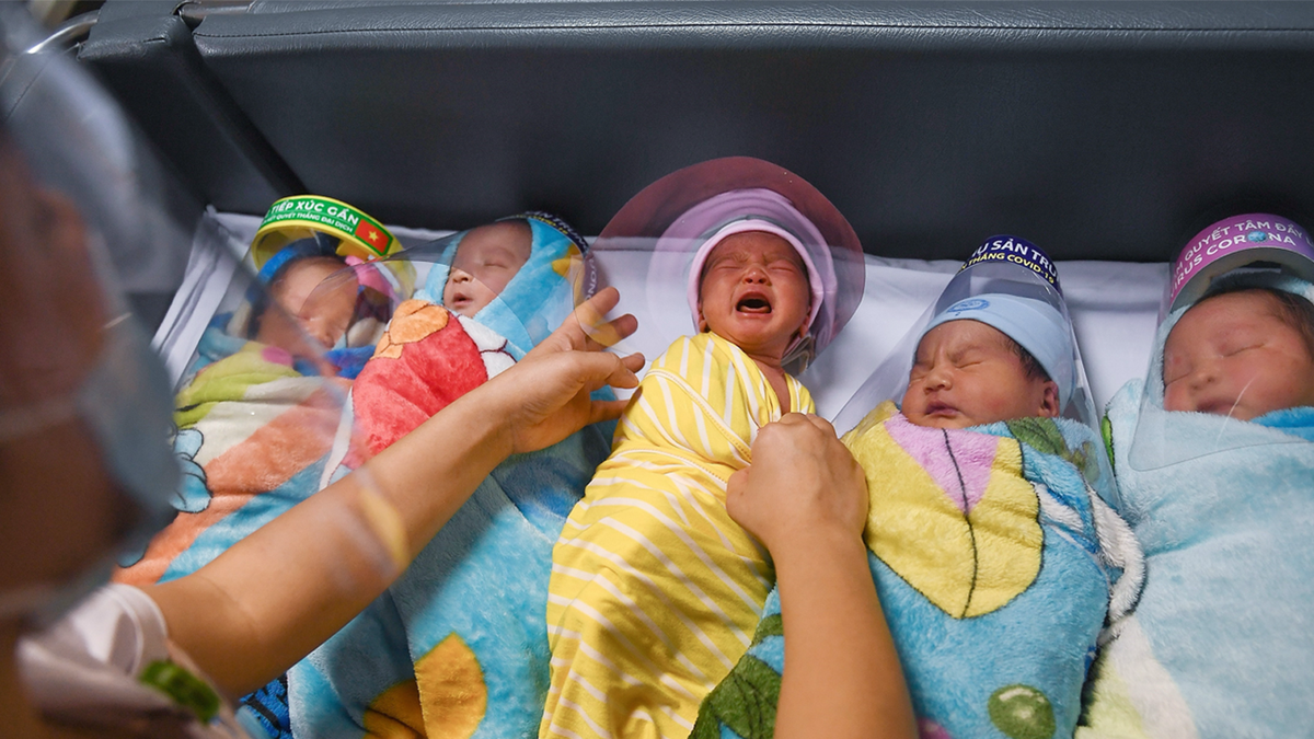 Vietnamese babies in a crib