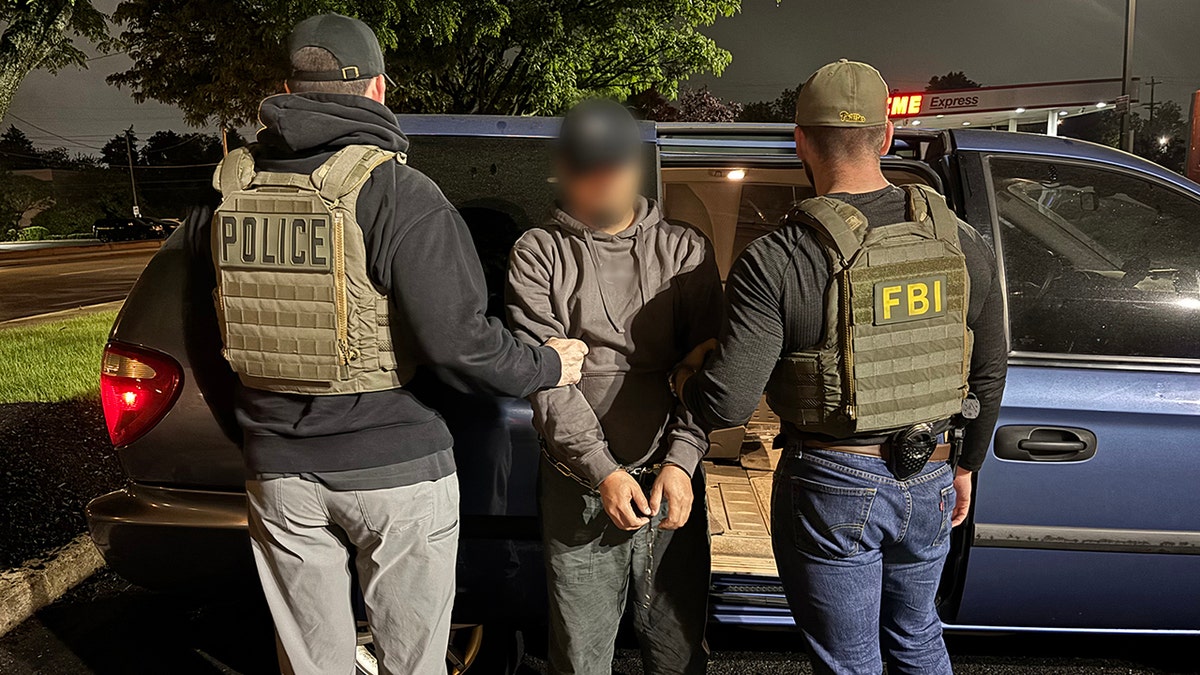 ICE arresting man, putting him into van