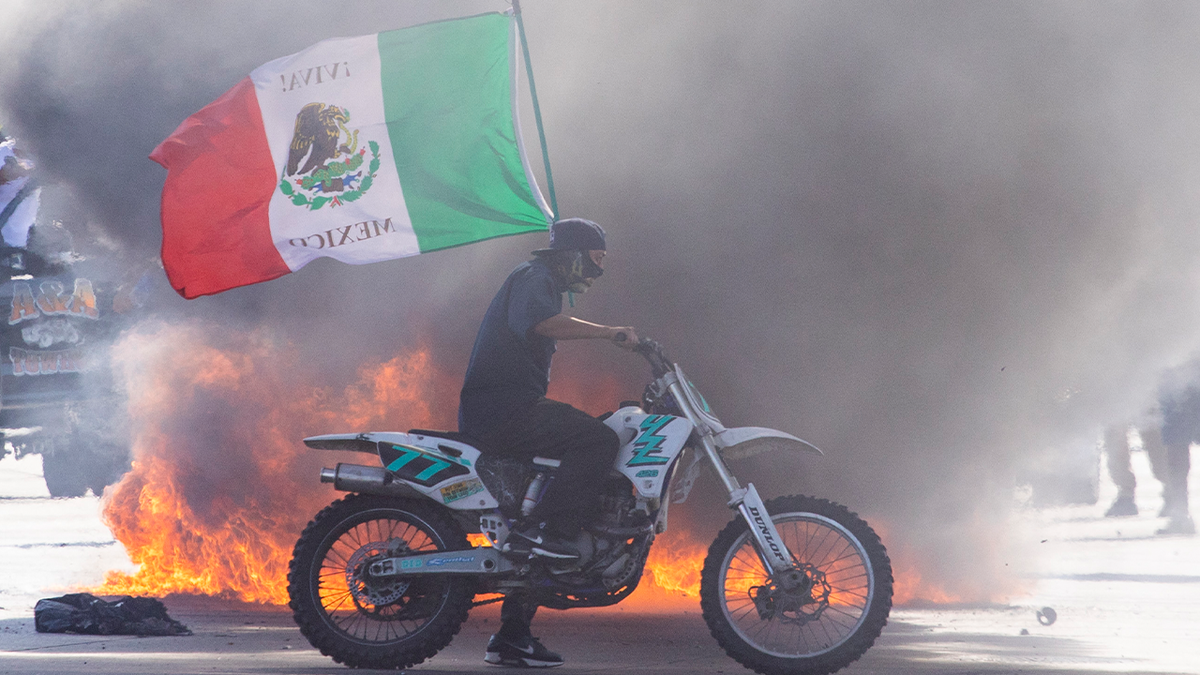 Rioter in LA on dirt bike with Mexican flag