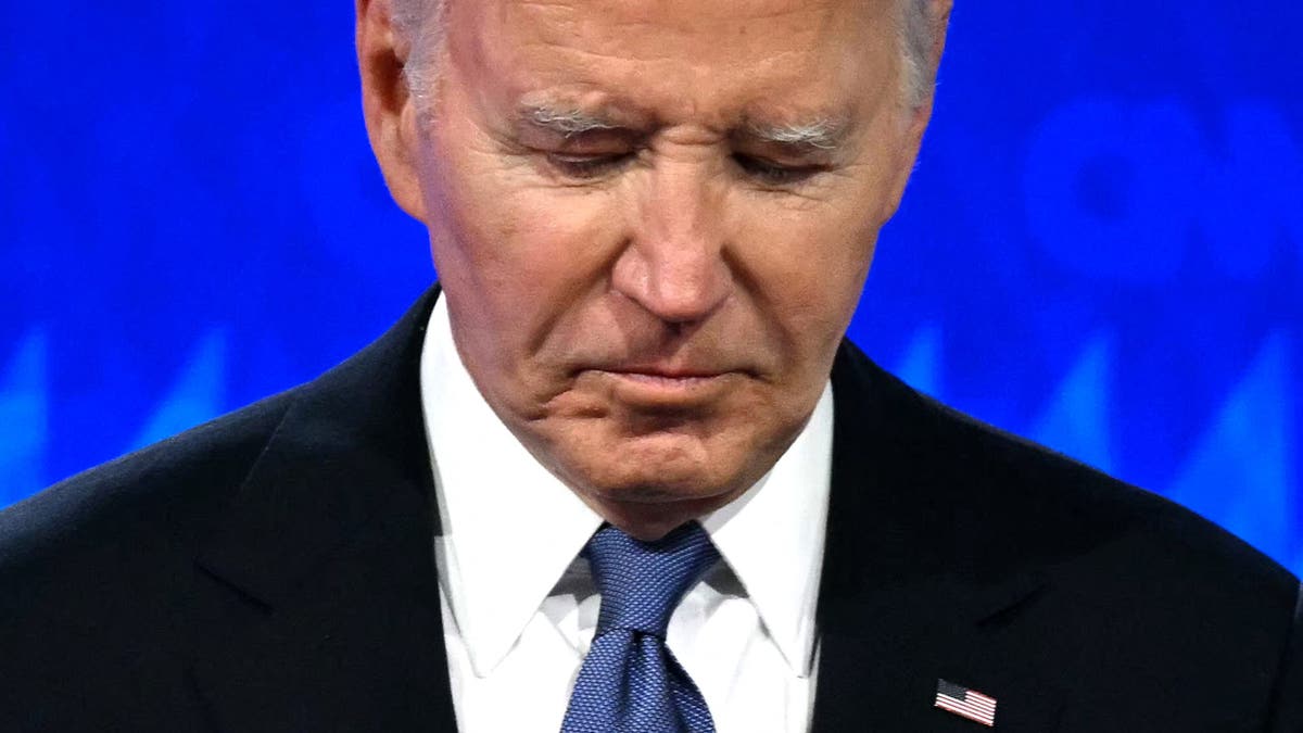 Then-President Joe Biden looks down as he participates in the first presidential debate of the 2024 elections with then-former President Donald Trump at CNN's studios in Atlanta on June 27, 2024.