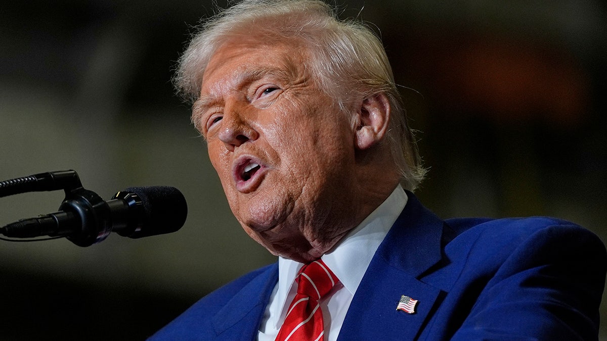 President Donald Trump in red tie speaking