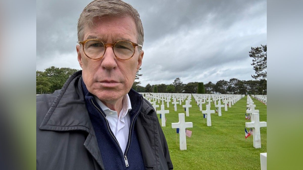 Greg Palkot takes a picture at a cemetery
