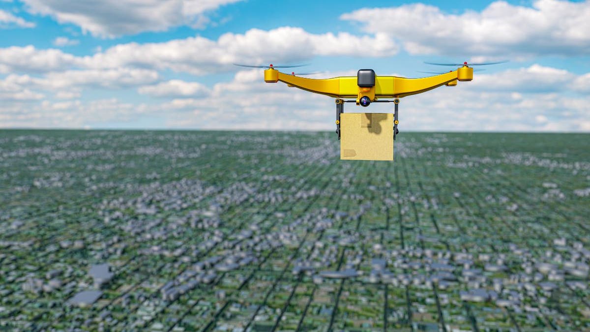Yellow drone flies over city