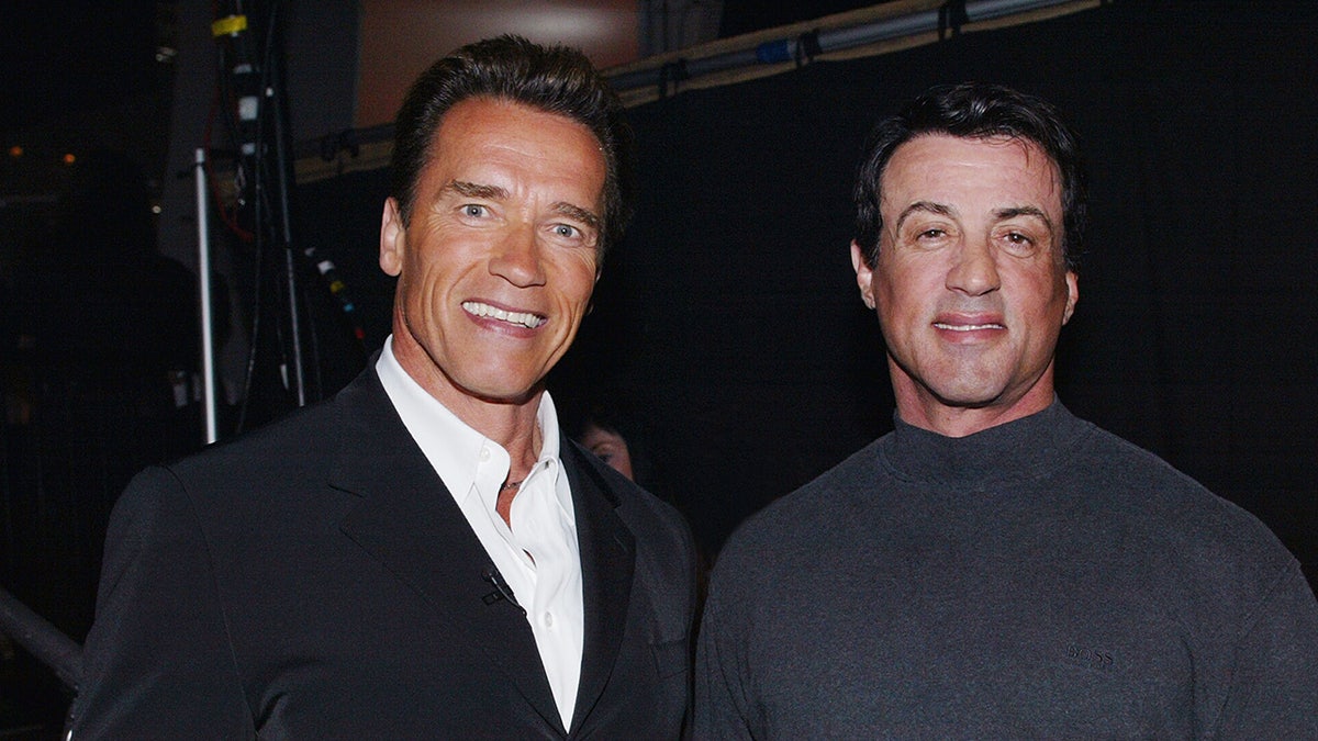 Arnold Schwarzenegger and Sylvester Stallone smiling