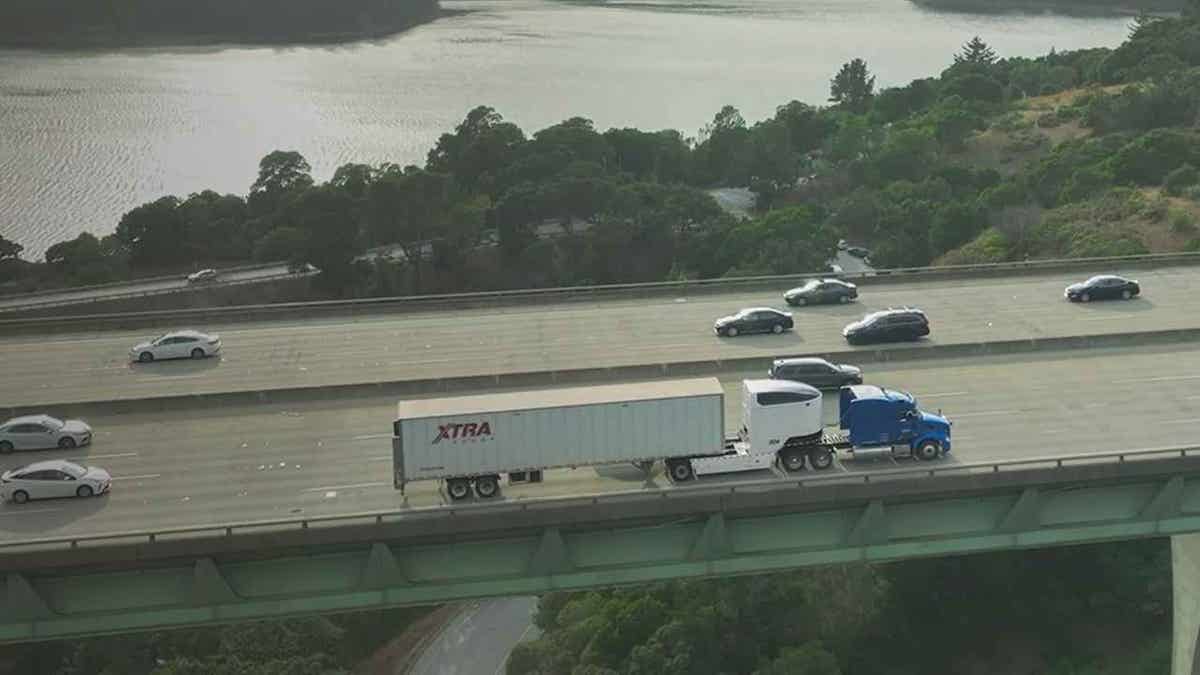 A big rig on the road using a high-tech electric dolly.