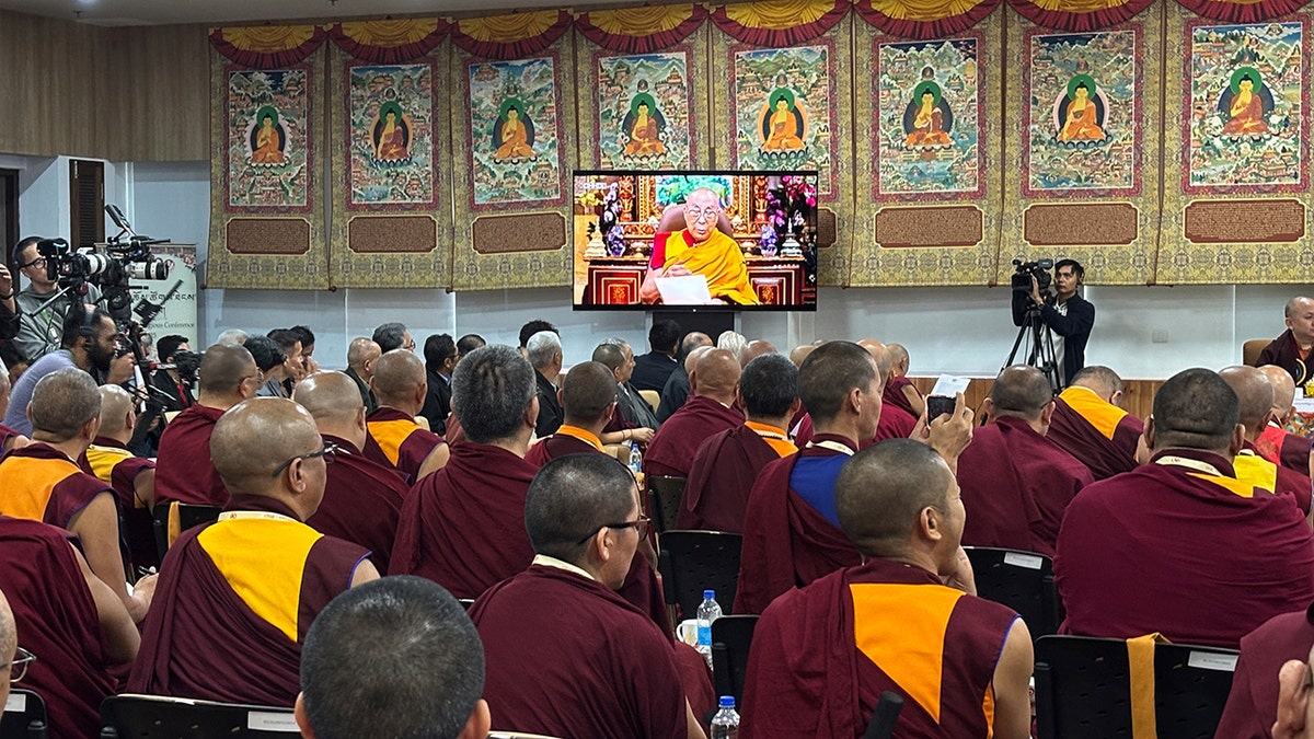 Monks listen to Dalai Lama