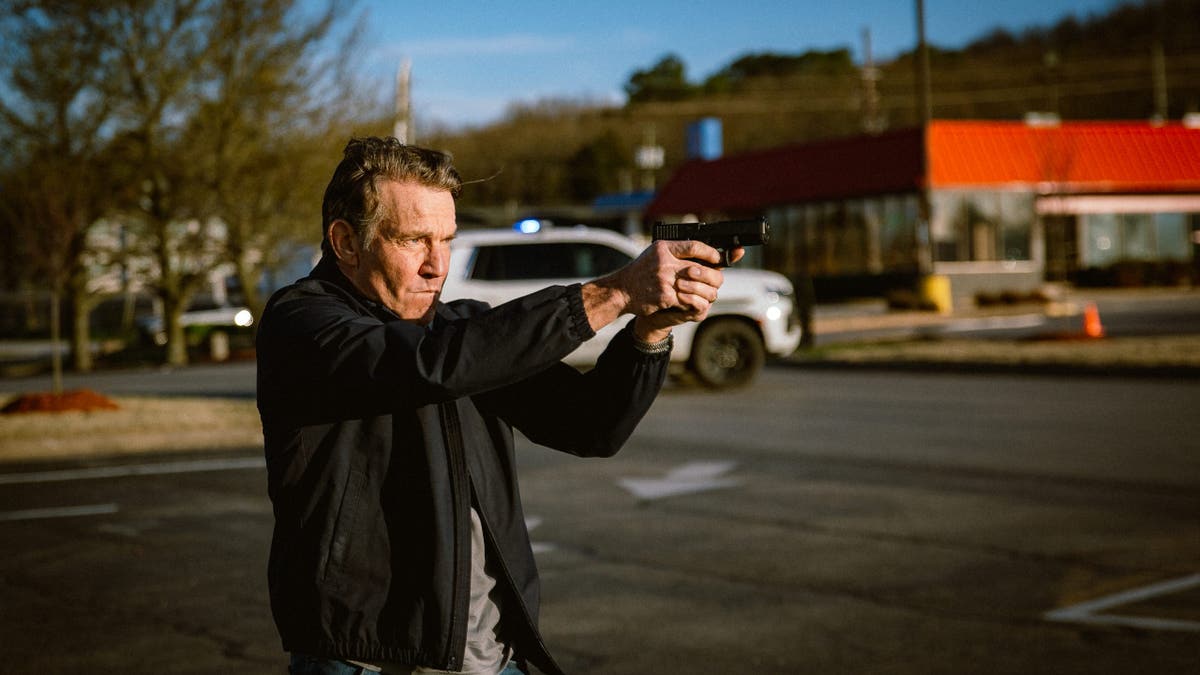 Dennis Quaid pointing a gun in the movie "Sovereign"