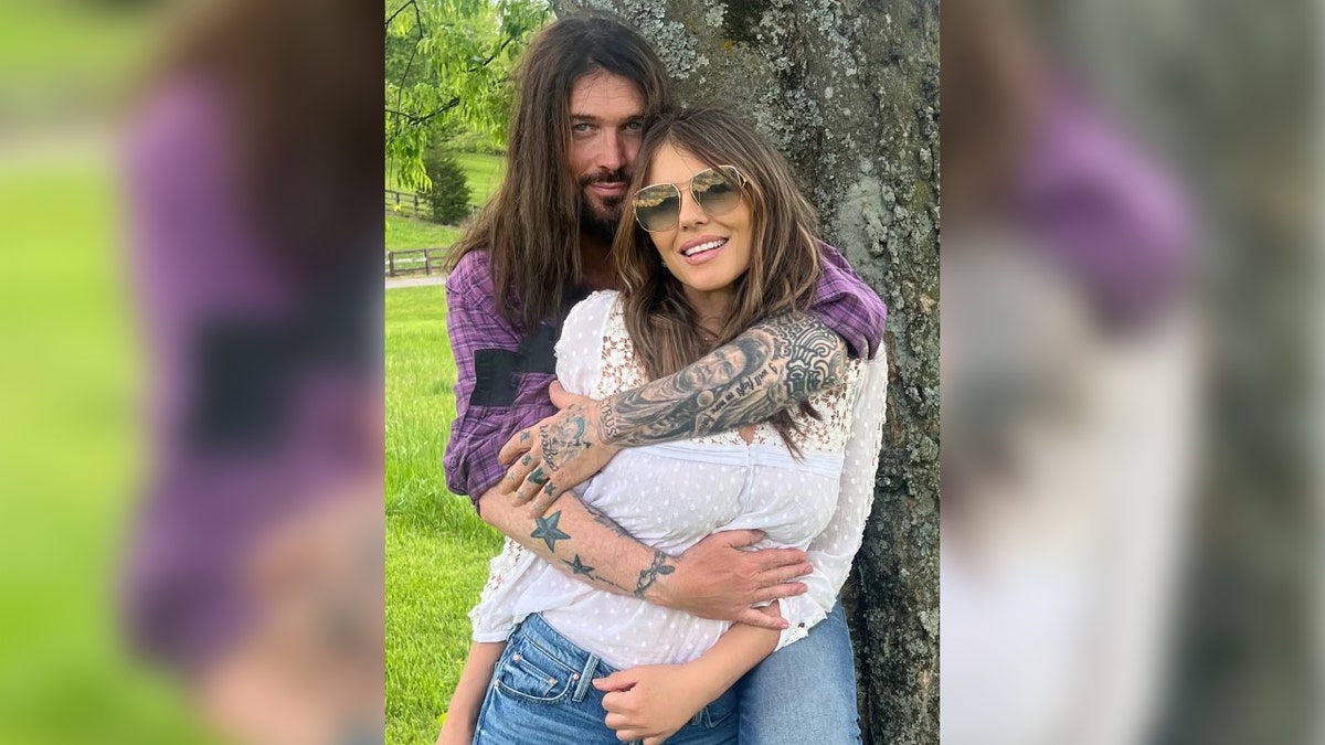 Elizabeth Hurley smiles with boyfriend Billy Ray Cyrus.