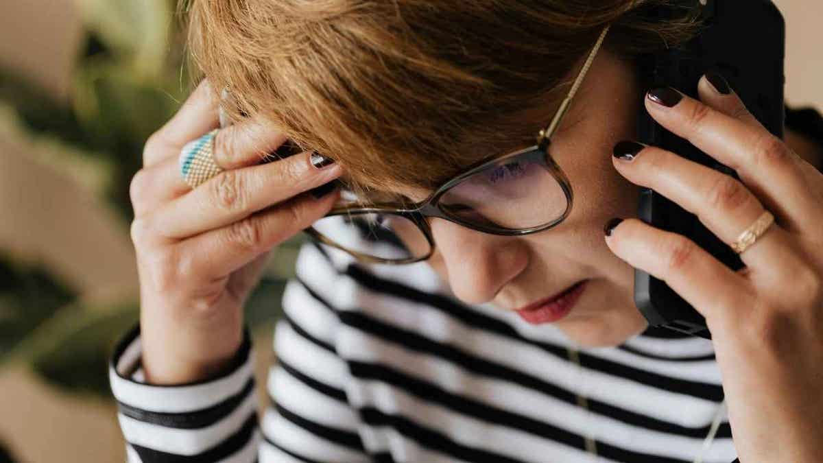 A woman receiving a fake scam phone call.