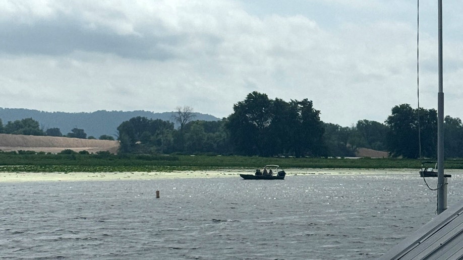 A photo taken by the marina bar owner's daughter shows authorities discovering Eliotte Heinz's body in the Mississippi River on Wednesday, July 23, 2025.