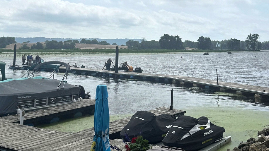 A photo taken by the marina bar owner's daughter shows authorities discovering Eliotte Heinz's body in the Mississippi River on Wednesday, July 23, 2025.