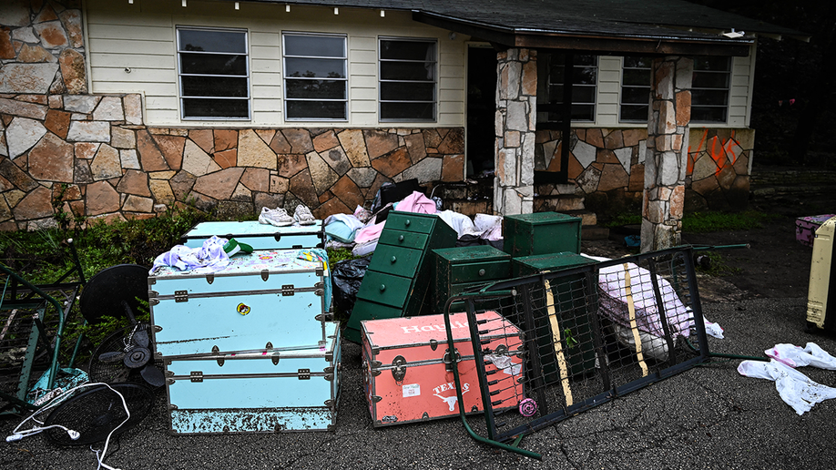 Suitcases and furniture are seen outside of a cabin at Camp Mystic on July 5, 2025.