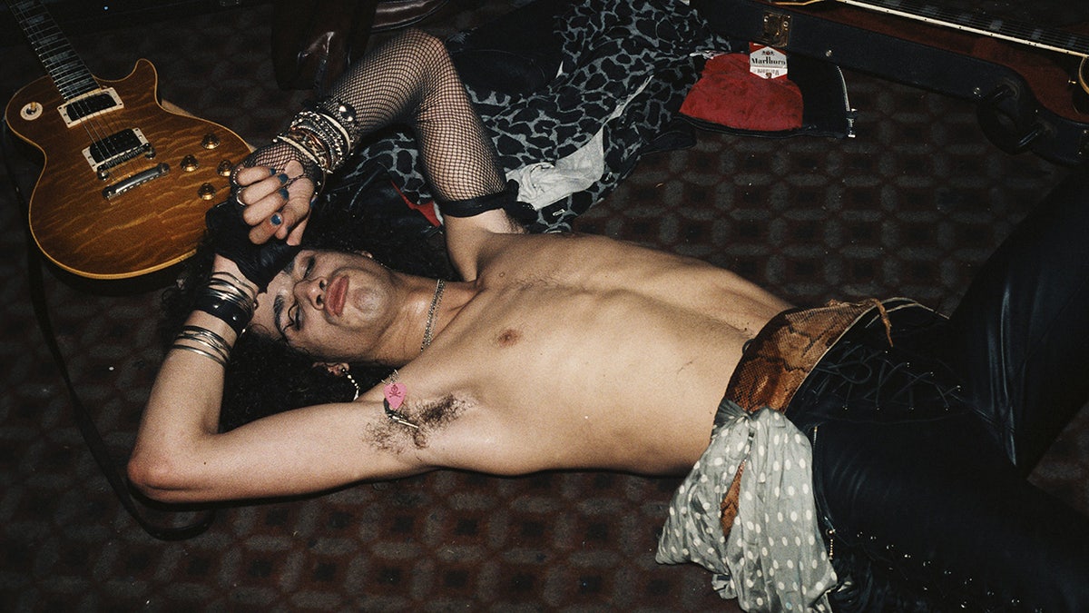 Slash laying on the floor with his eyes closed.