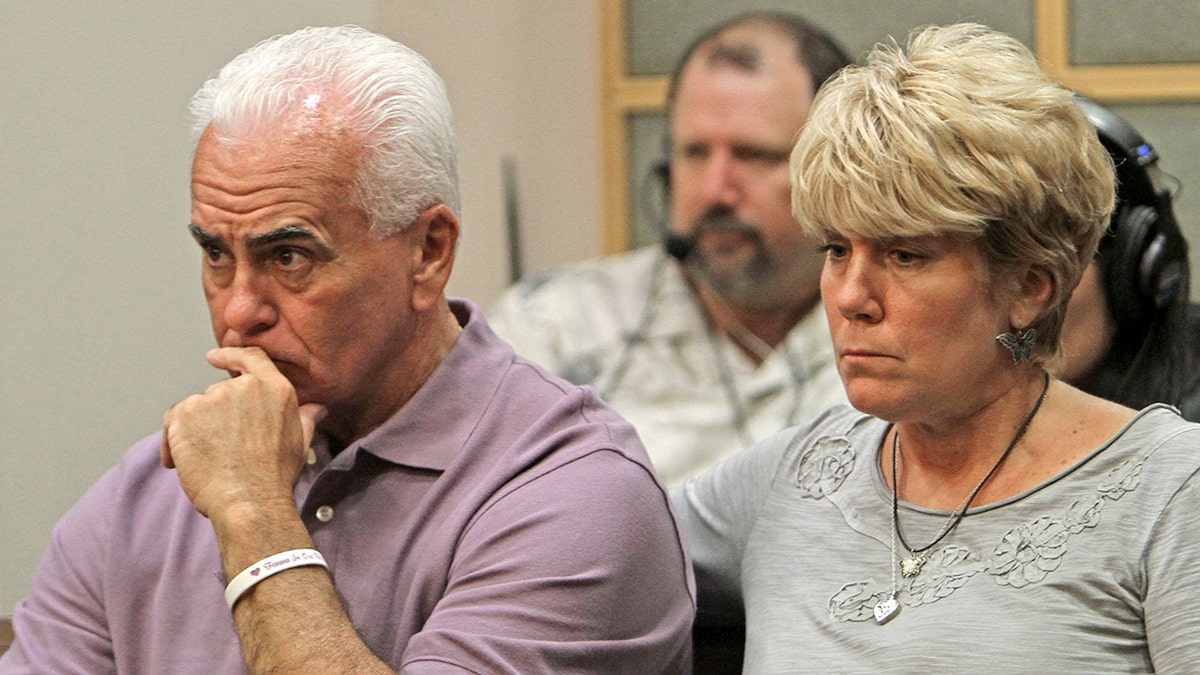 Casey Anthony's parents looking worried in court wearing casual shirts.