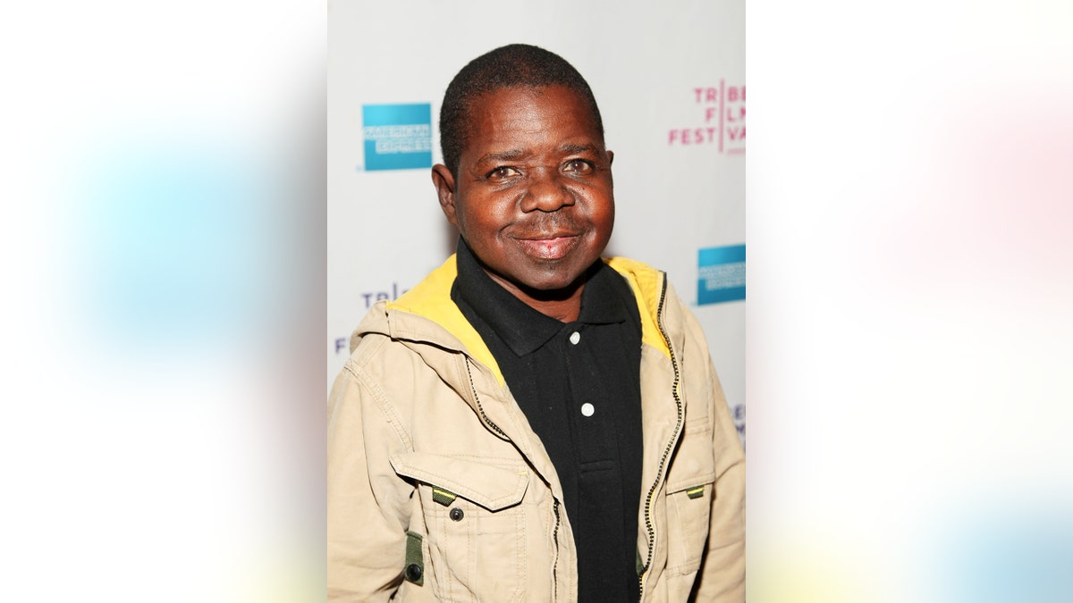 Gary Coleman wearing a beige sweater and a black shirt.