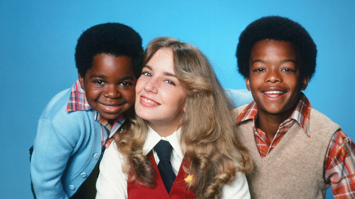 Gary Coleman smiling with his co-stars on Diff'rent Strokes.