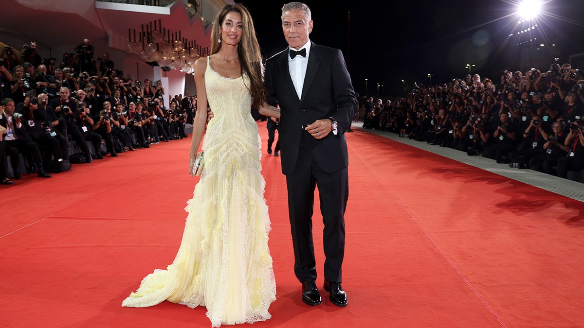 George Clooney sports black tux with wife Amal in yellow dress