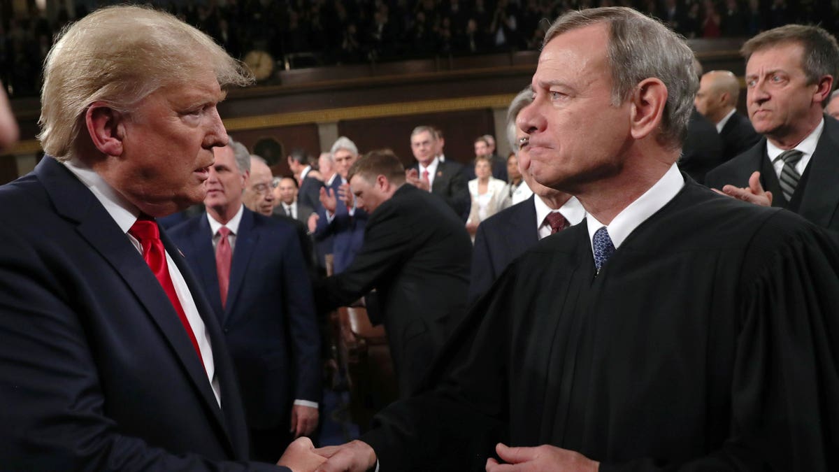 Chief Justice John Roberts and Donald Trump shake hands