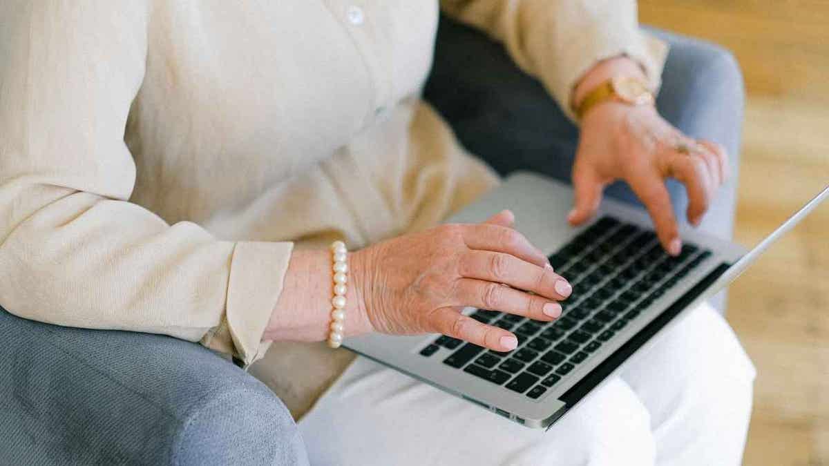 A woman typing on her laptop.