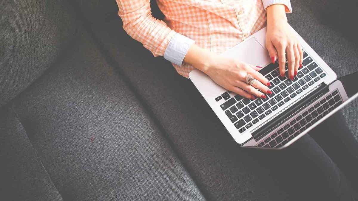 A woman typing on her laptop.