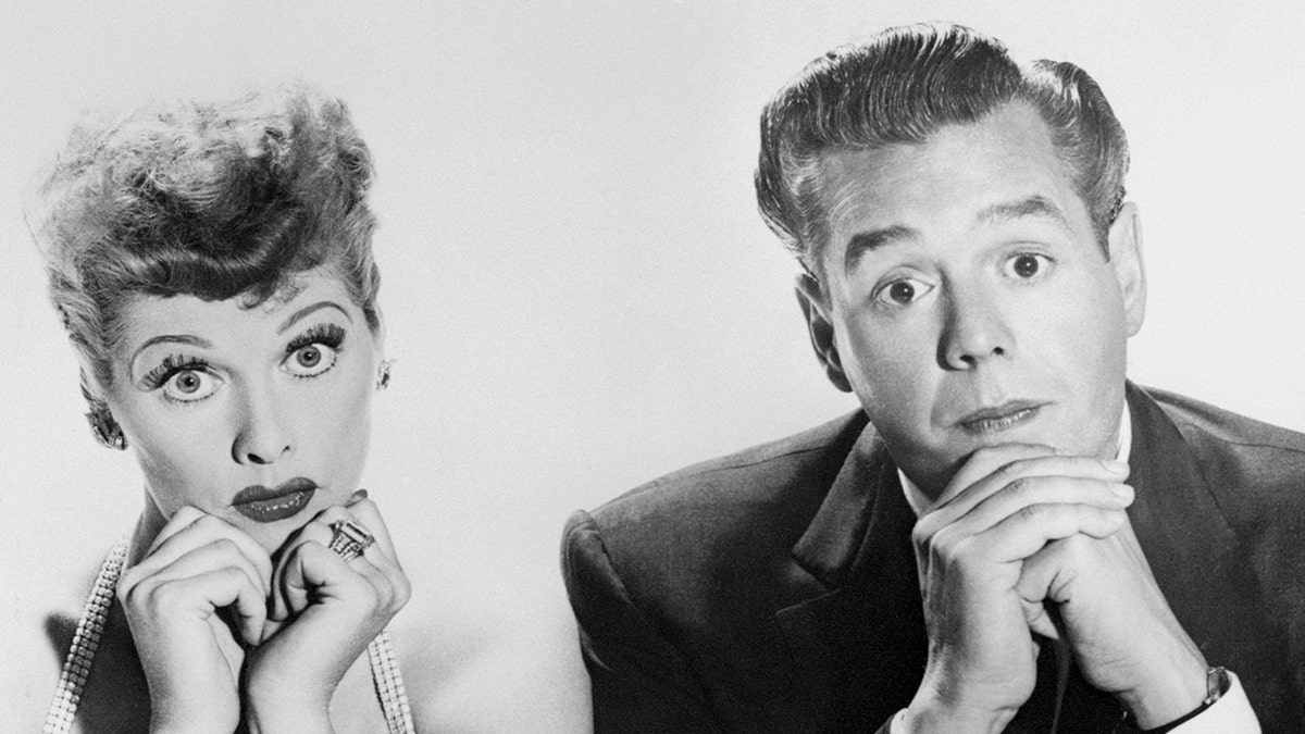 Lucille Ball and Desi Arnaz looking surprised.