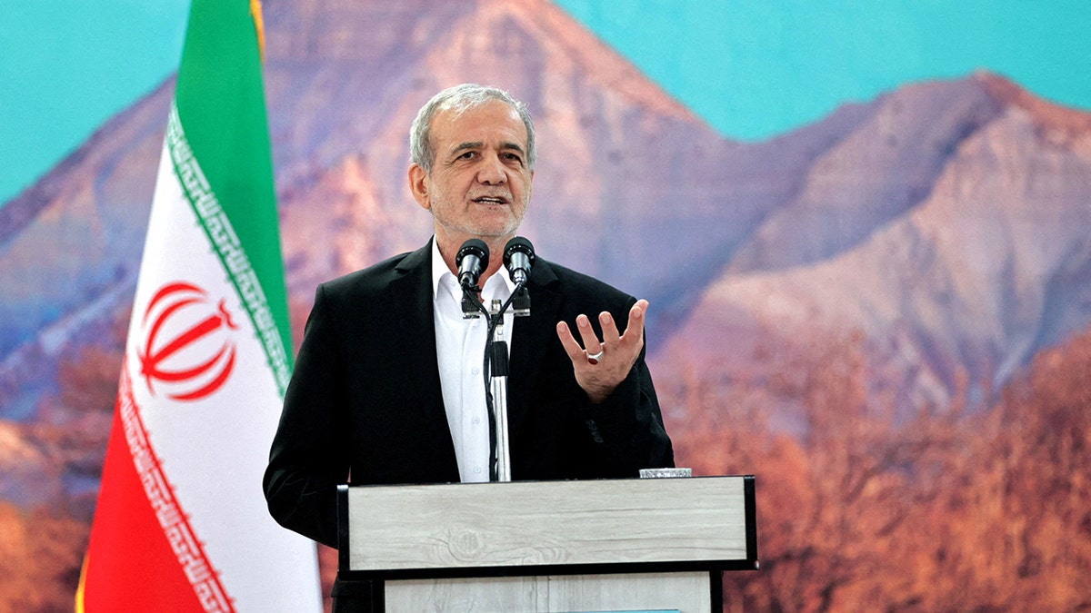 Iranian President Masoud Pezeshkian speaking at a podium in front of Iranian flag